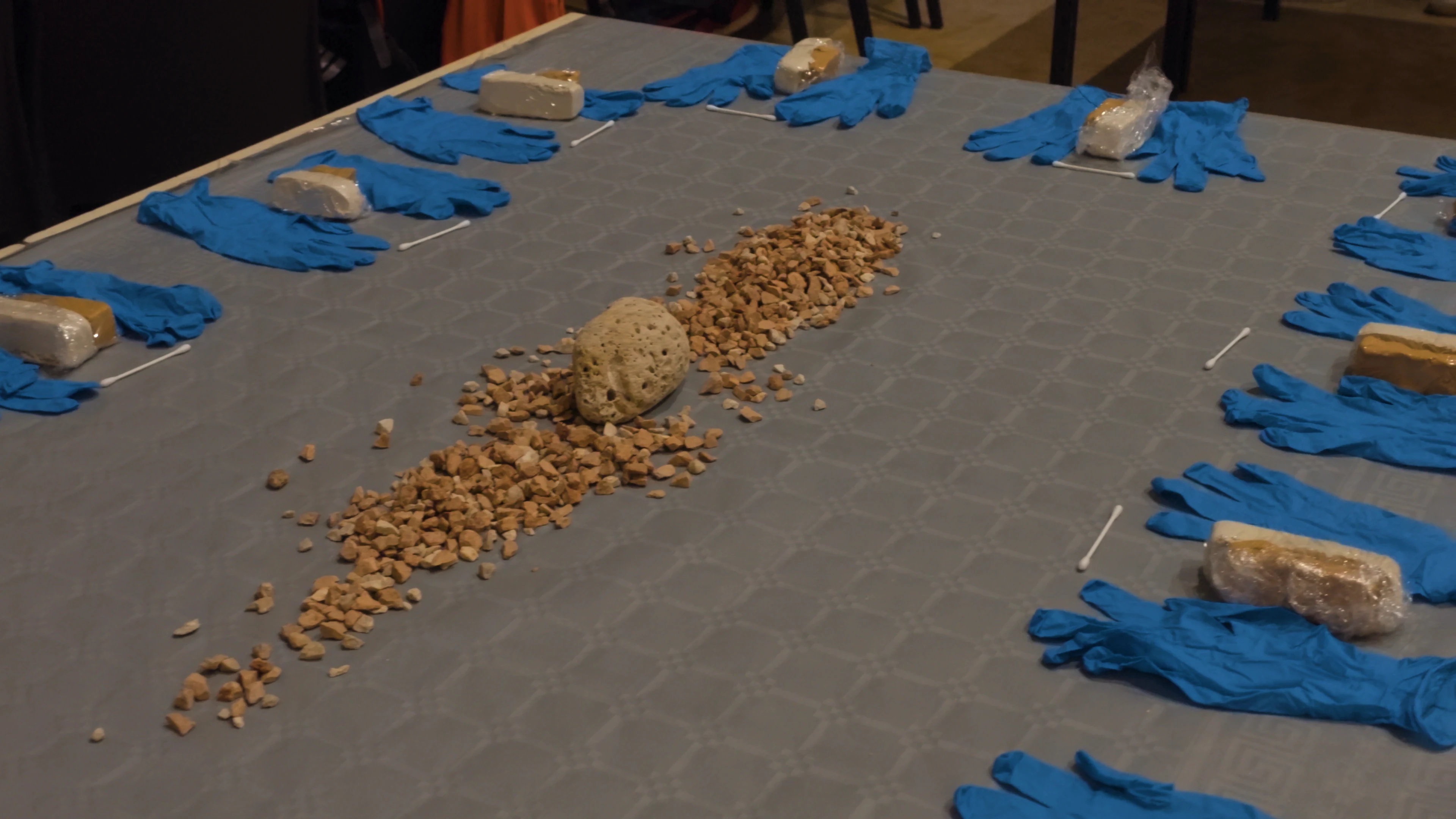 Clay, gloves and stones laid out on the workshop table before the Hera evening